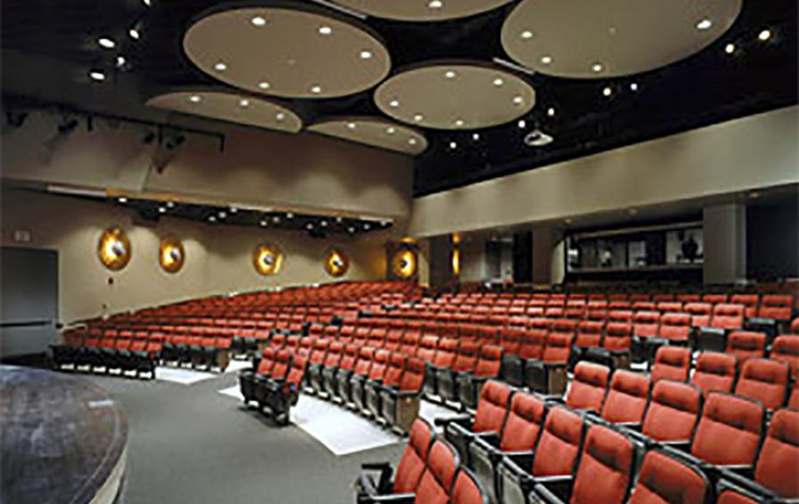 Auditorium space in Coffman Memorial Union featuring seating with plush red upholstery